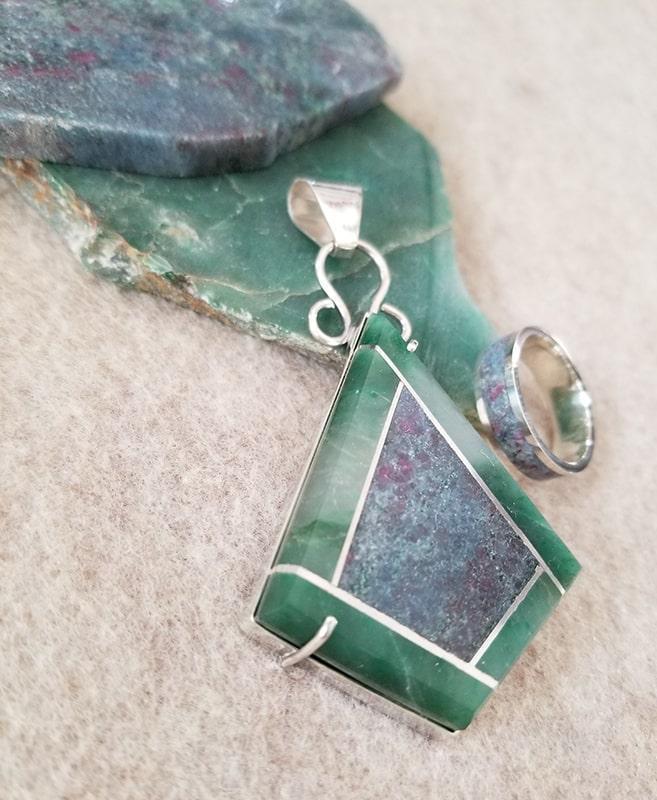 Beautiful stone intarsia diamond-shaped pendant made of Kyanite Ruby & Fuschite with a border ofGreen Chalcedony and a sterling silver bezel