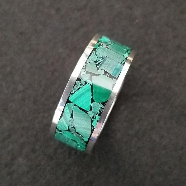 Malachite inlay ring with sterling silver band and dark background
