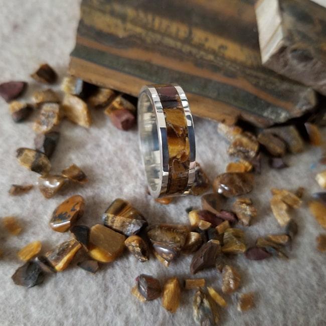 Sterling silver ring band with tiger eye inlay and rough tiger eye slab and stones