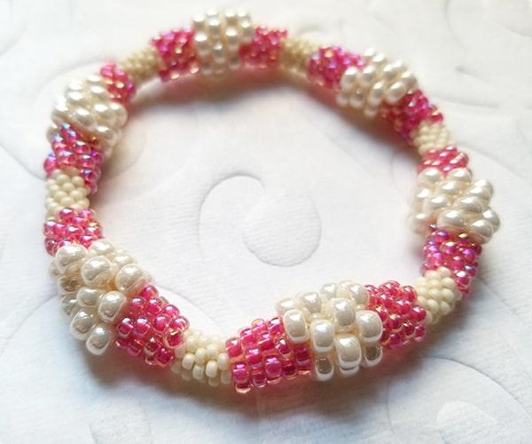 Bead crochet bracelet with multiple size beads in pink & ivory
