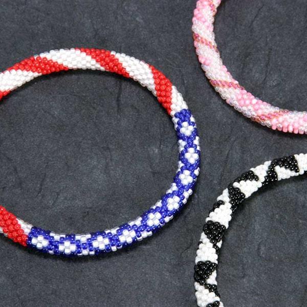 Bead crochet bracelets with different patterns: stars & stripes, trianbles, and breast cancer ribbon