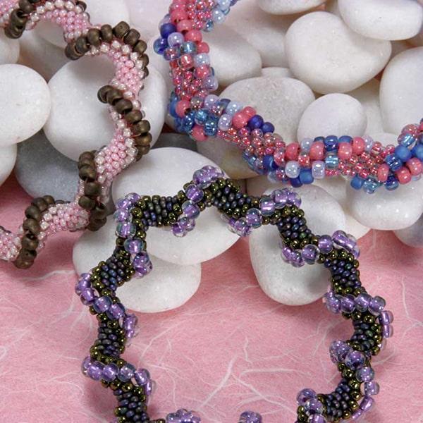 Wavy bead crochet bracelets in multiple colors: purples, brown/pink, and pinks/blues