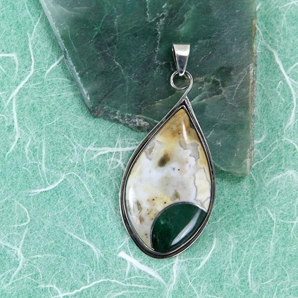 A teardrop shaped stone intarsia pendant made of ocean jasper and green chalcedony