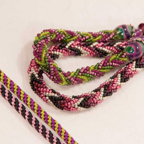 Several multi-colored necklace made from strands of beads using the kumihimo technique