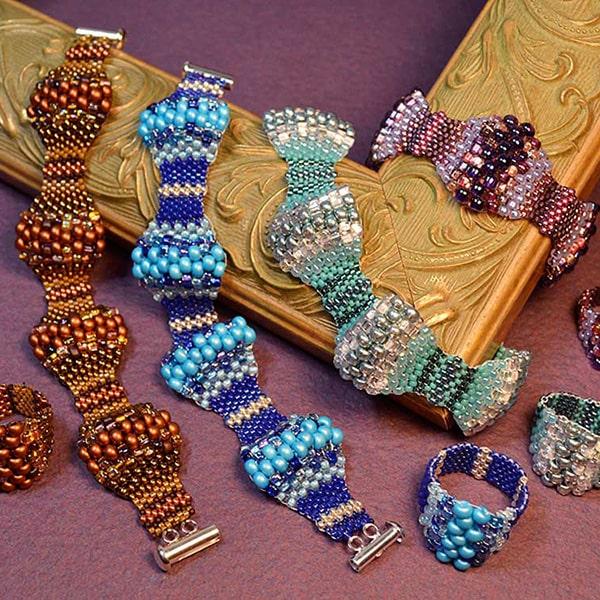 Multiple colorful peyote stitched bracelets with various sizes of beeds making a wave shape