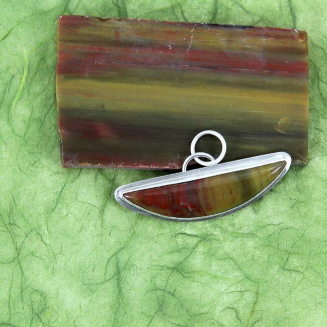 Petrified wood from AZ fashioned into a mezzaluna or half-moon shaped pendant in sterling silver.