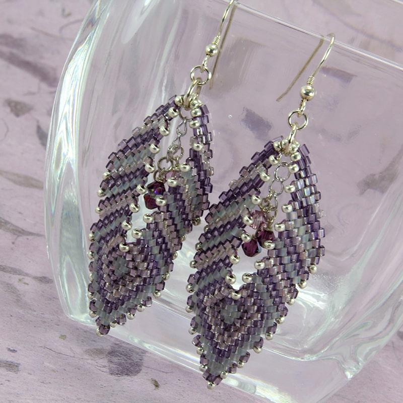 Beaded brick stitch earrings in purple with swarovski crystals