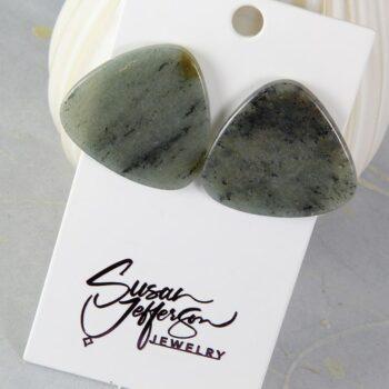 Post earrings ina translucent light green stone with black and brown inclusions.