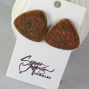 Post earrings in a rounded triangle shape in red and black granite.