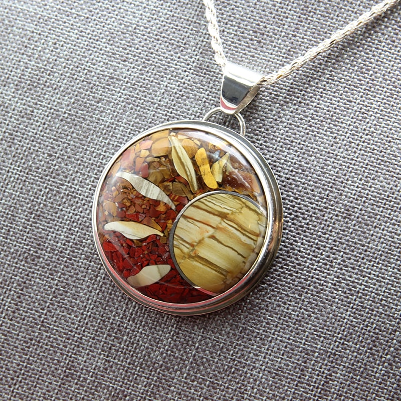 Sterling silver and stone inlay pendant of owyee jasper, red jasper, petrified wood, and tiger eye