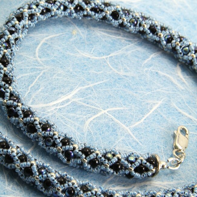Light blue and black beaded netted necklace