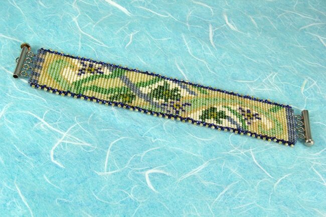 Square stitch beaded bracelet with flower and vine pattern
