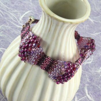 Peyote stitch bracelet with multiple size beads in various shades of tealPeyote stitch bracelet with multiple size beads in various shades of purple and magenta