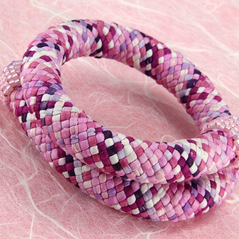 Pink & purple kumihimo bracelet with silk strands