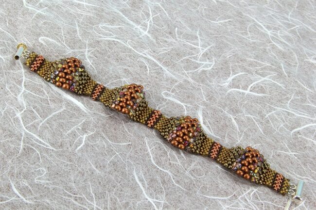 Peyote stitch bracelet with multiple size beads in various shades of tealPeyote stitch bracelet with multiple size beads in various shades of brown and copper
