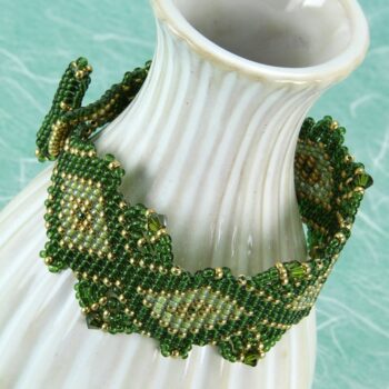 Beaded bracelet in green and gold embellished with Swarovski crystals
