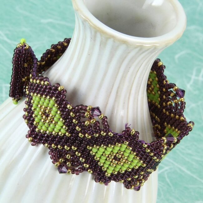 Beaded bracelet in purple, chartreuse and gold embellished with Swarovski crystals